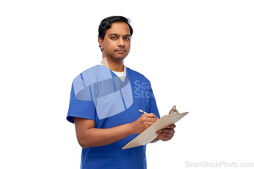 Image of male doctor writing medical report on clipboard