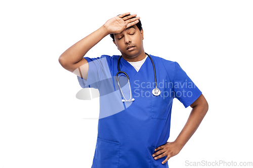 Image of stressed doctor or male nurse in blue uniform