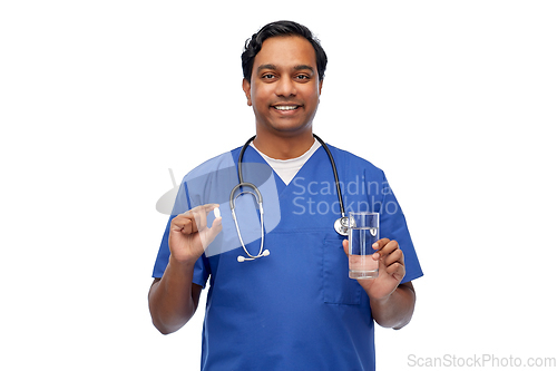 Image of indian doctor with medicine and glass of water