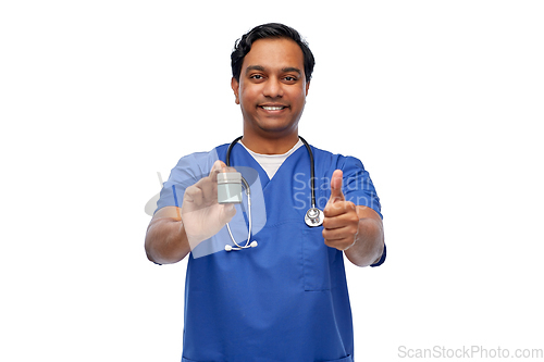 Image of indian male doctor with medicine showing thumbs up