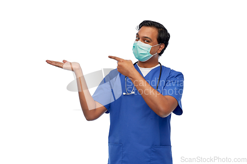 Image of indian male doctor in blue uniform and mask