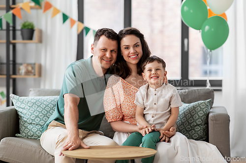 Image of happy family with little son at home party