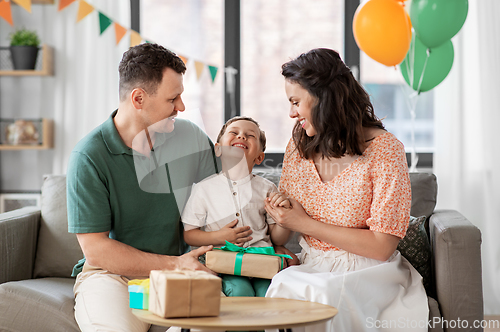 Image of parents giving birthday present to little son