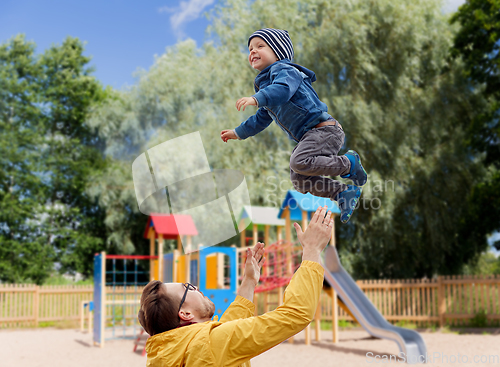 Image of father with son playing and having fun outdoors