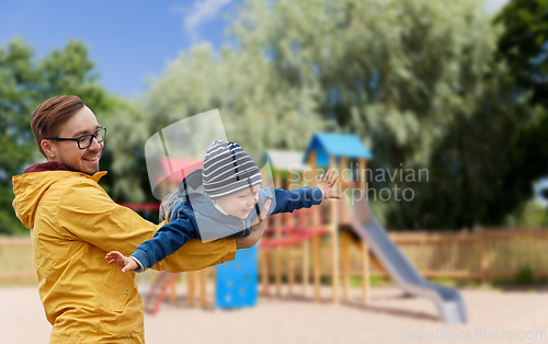 Image of father with son playing and having fun outdoors