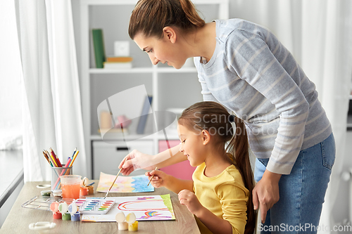 Image of mother with little daughter drawing at home