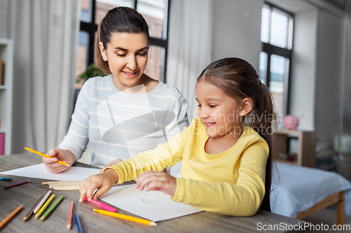 Image of mother with little daughter drawing at home