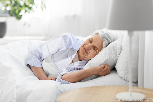 Image of senior woman sleeping in bed at home bedroom