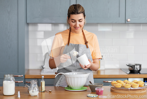 Image of woman cooking food and baking on kitchen at home