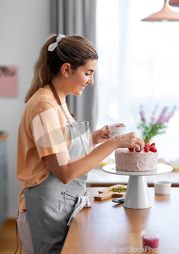 Image of woman cooking food and baking on kitchen at home