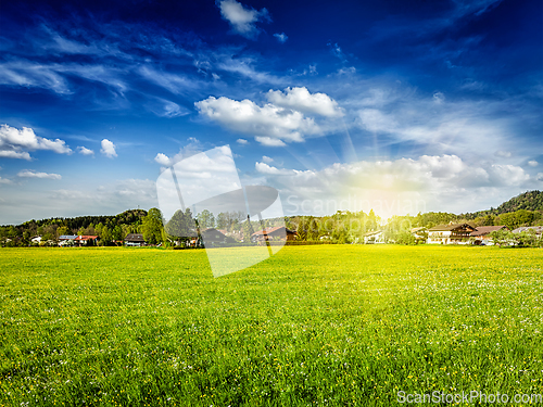 Image of Countryside meadow field with sun and blue sky