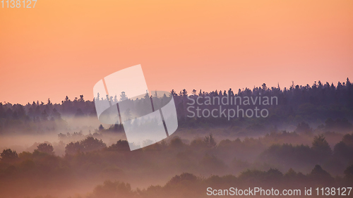 Image of Misty morning of hilly area with ray of light.