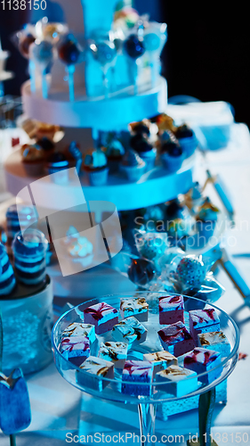 Image of Selection of decorative desserts on buffet table at catered event