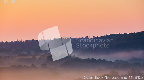 Image of Misty morning of hilly area with ray of light.