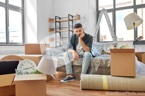 Image of sad man with boxes moving to new home