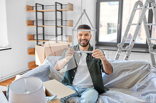 Image of happy man with boxes moving to new home