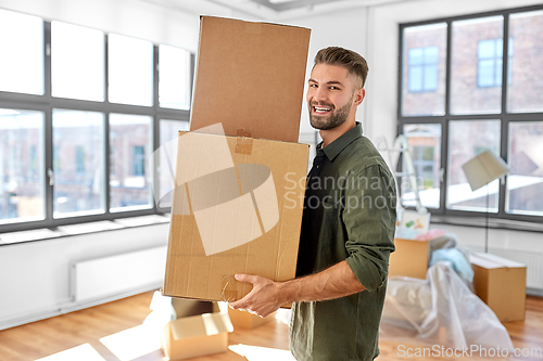 Image of happy man with boxes moving to new home