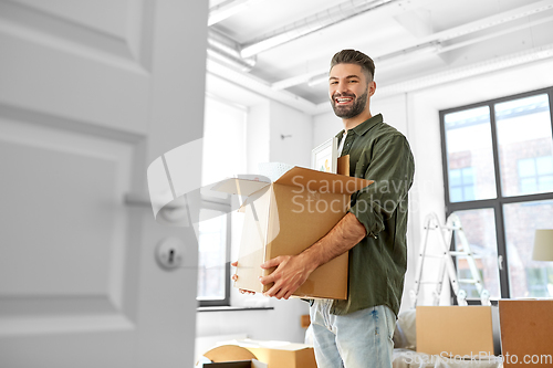 Image of happy man with box moving to new home