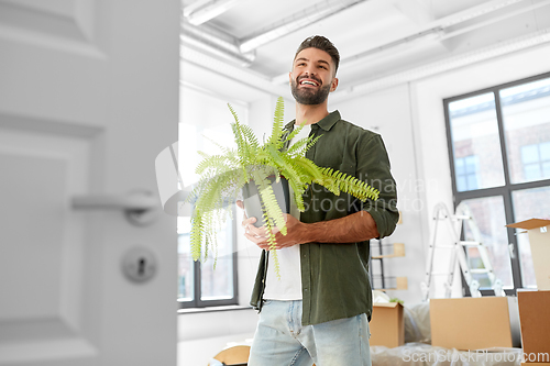 Image of happy man with fern flower and moving to new home