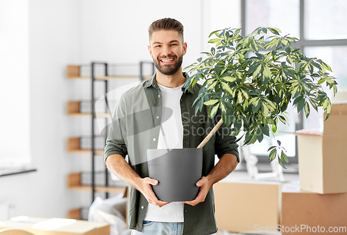 Image of happy man with flower moving to new home