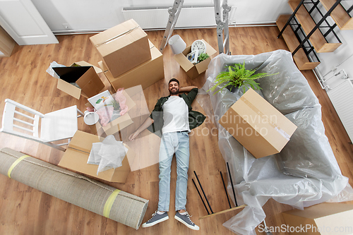 Image of happy man with boxes moving to new home