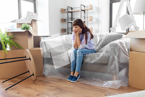 Image of sad asian woman with stuff moving to new home