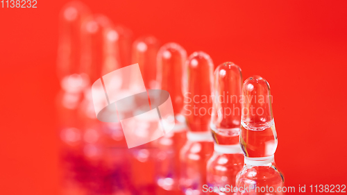 Image of Medical ampules on a red background, selective focus. 