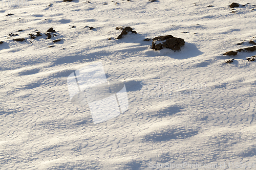 Image of covered with snow plowed earth ,