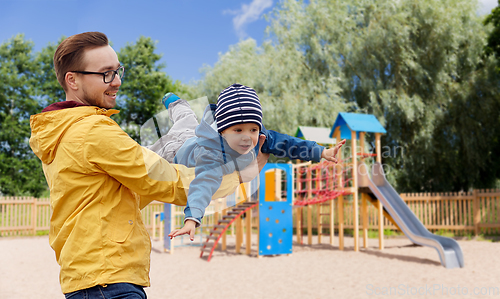 Image of father with son playing and having fun outdoors