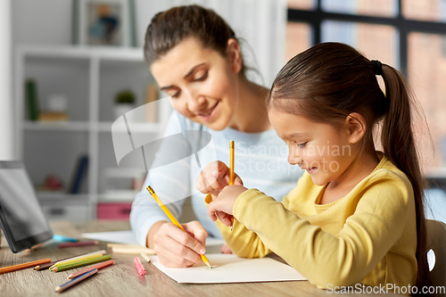 Image of mother with little daughter drawing at home