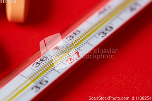 Image of Mercury thermometer and medical pills on background