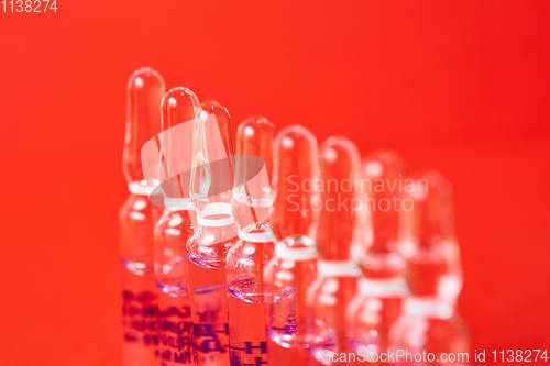 Image of Medical ampules on a red background, selective focus. 