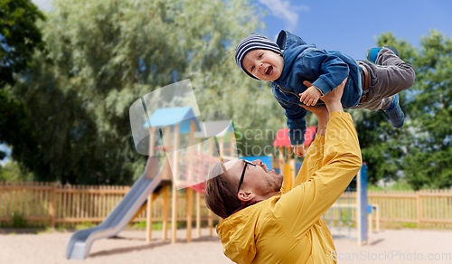 Image of father with son playing and having fun outdoors