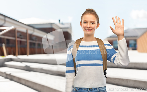 Image of smiling teenage student girl with school bag