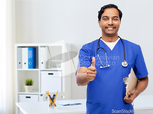 Image of smiling doctor or male nurse showing thumbs up