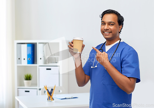 Image of male doctor with stethoscope drinking coffee