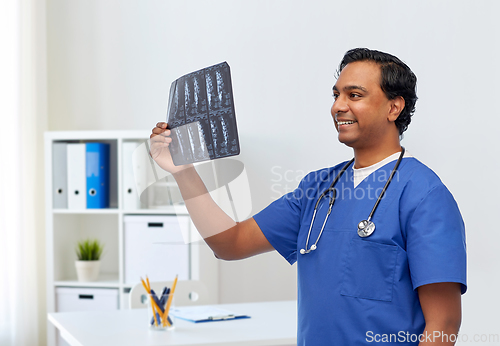 Image of happy indian doctor or male nurse with x-ray