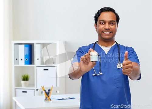 Image of indian male doctor with medicine showing thumbs up