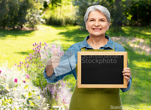 Image of senior gardener with chalkboard showing thumbs up