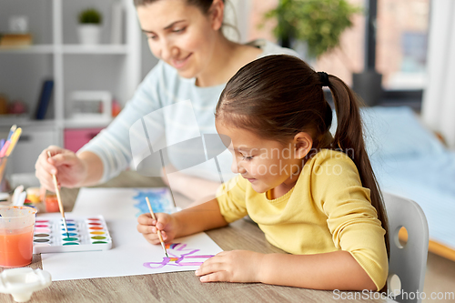 Image of mother with little daughter drawing at home