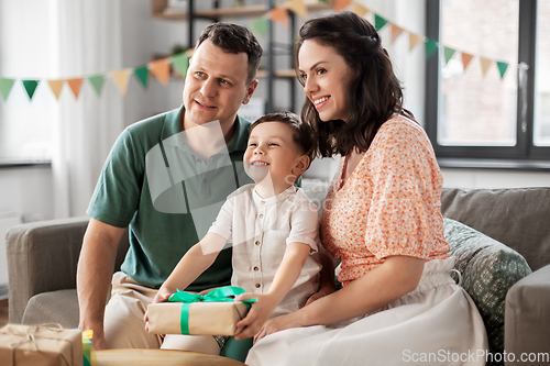 Image of parents giving birthday present to little son