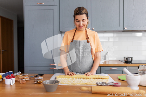 Image of woman cooking food and baking buns at home kitchen