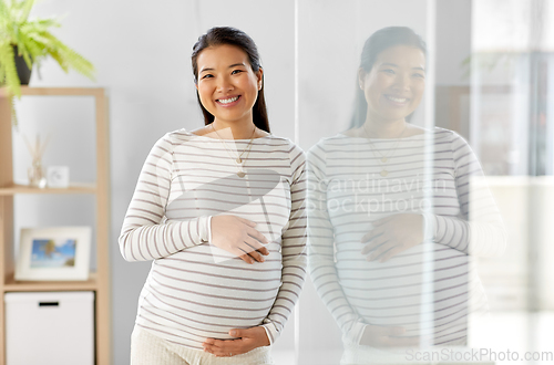 Image of happy pregnant asian woman at home