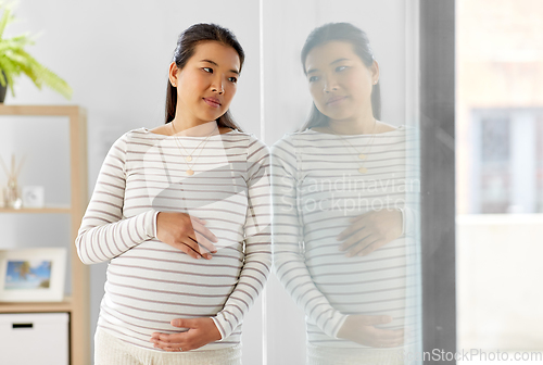 Image of pregnant asian woman at home