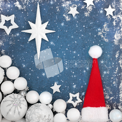 Image of Christmas Eve Background with Santa Hat and Tree Baubles 
