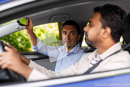 Image of car driving school instructor teaching male driver