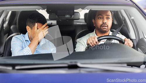 Image of car driving school instructor and male driver
