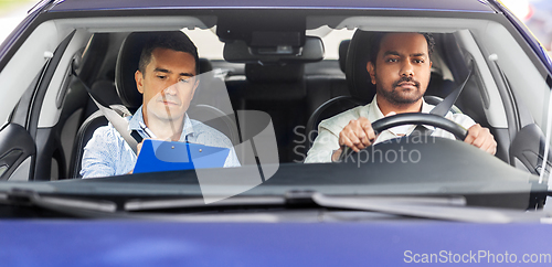 Image of car driving school instructor and young driver