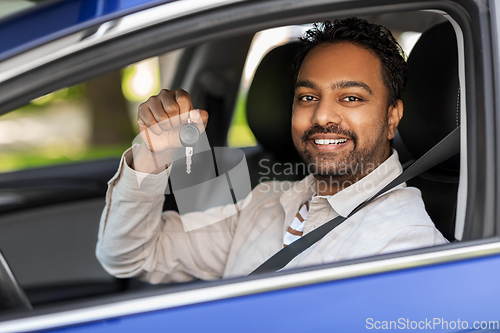 Image of smiling indian man or driver showing car key