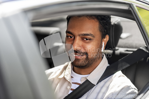 Image of man or driver with wireless earphones driving car